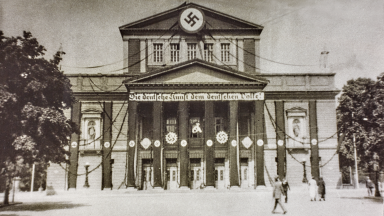 Historisches Foto: Blick auf das Landestheater in Darmstadt mit Hakenkreuzbannern und dem Schriftzug "Die deutsche Kunst dem deutschen Volke!", 1935 (HStAD, R 4, 29331)