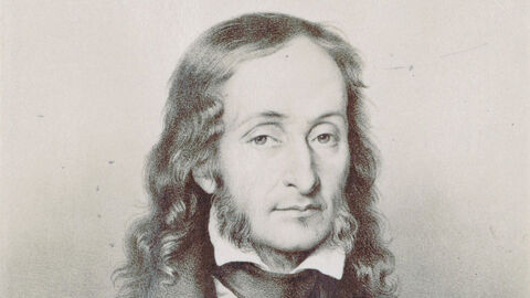 schwarz-weiß Bildnis eines Mannes mit längeren Haaren