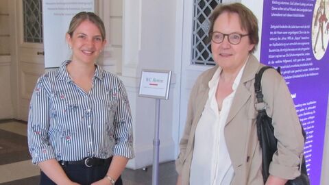 v.l.n.r. Archivarin Karina Jaeger, Christiane Kessler. Zwei Frauen stehen nebeneinander und lächeln in die Kamera